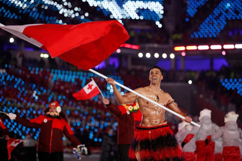 Pita Taufatofua carries the flag of Tonga during the opening ceremony of the 2018 Winter Olympics in Pyeongchang, South Korea, Friday, Feb. 9, 2018. (AP Photo/Jae C. Hong)