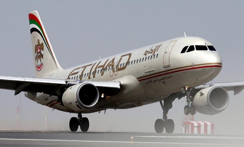 An Etihad Airbus A320 touches down on Abu Dhabi airport. Andrew Parsons / The National