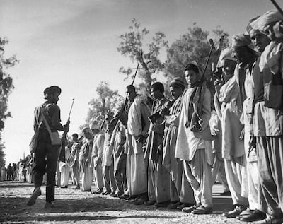 December 1947: Armed Pathan tribesmen waiting on road between Peshawar. Getty Images