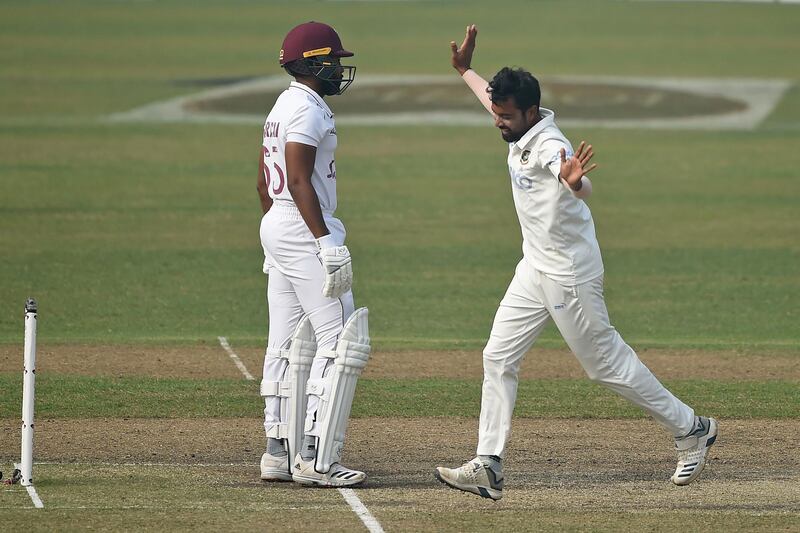 Bangladesh's Abu Jayed, right, after taking the wicket of West Indies' Jomel Warrican. AFP
