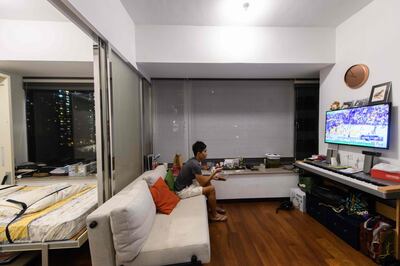 In this photo taken on May 23, 2018, finance worker Adrian Law, 25, eats a delivered meal while watching television in his studio apartment, for which he paid more than 765,000 USD two years ago in a new development in the gentrified Sai Ying Pun neighbourhood of Hong Kong. As housing prices spiral in Hong Kong, young professionals are living in ever-shrinking spaces, with box-like "nano-flats" and co-shares touted as fashionable solutions. - TO GO WITH AFP STORY: Hong Kong-housing-social-lifestyle-urban-planning, FEATURE Yan ZHAO

 / AFP / Anthony WALLACE / TO GO WITH AFP STORY: Hong Kong-housing-social-lifestyle-urban-planning, FEATURE Yan ZHAO

