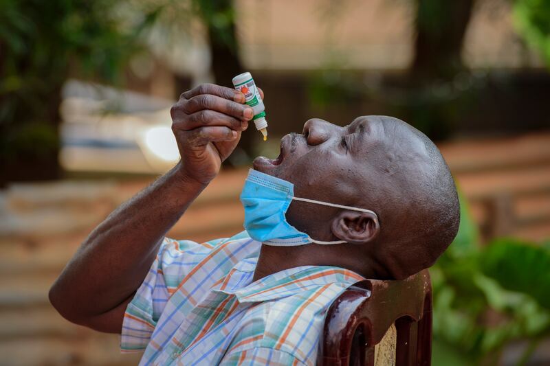 A man takes herbal medication for Covid-19 in Kampala, Uganda, in 2021. The pandemic led to vaccine inequity around the world. AP