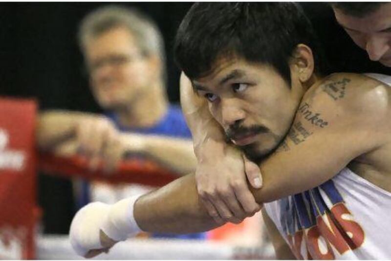 Manny Pacquiao gets help stretching before a workout in Texas this week.