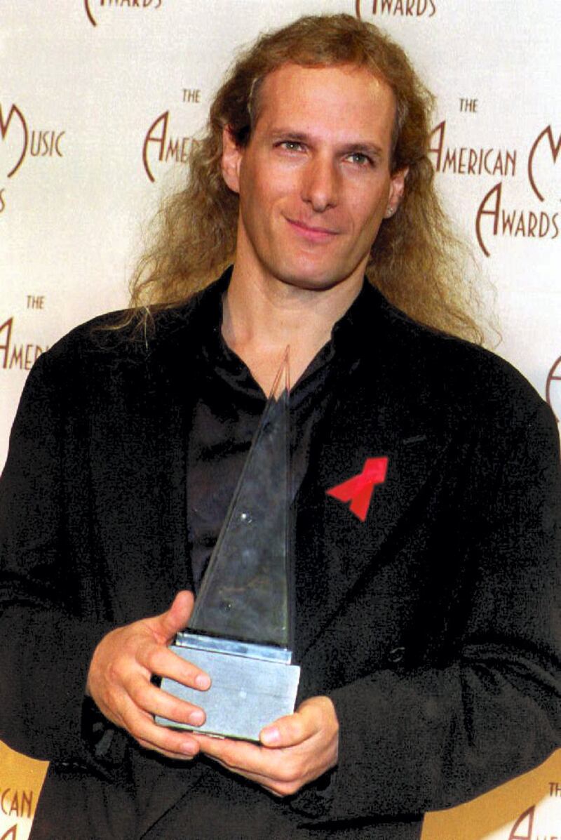 Singer Michael Bolton holds one of two trophies he won 25 January 1993 at the American Music Awards in Los Angeles, CA. (Photo by VINCE BUCCI / AFP)