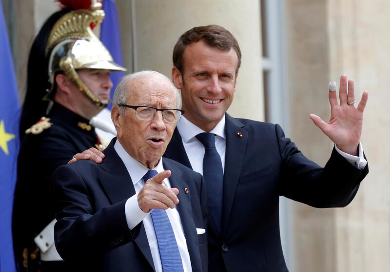 FILE PHOTO: French President Emmanuel Macron accompanies Tunisia's President Beji Caid Essebsi after an international conference on Libya at the Elysee Palace in Paris, France, May 29, 2018.  REUTERS/Philippe Wojazer/File Photo
