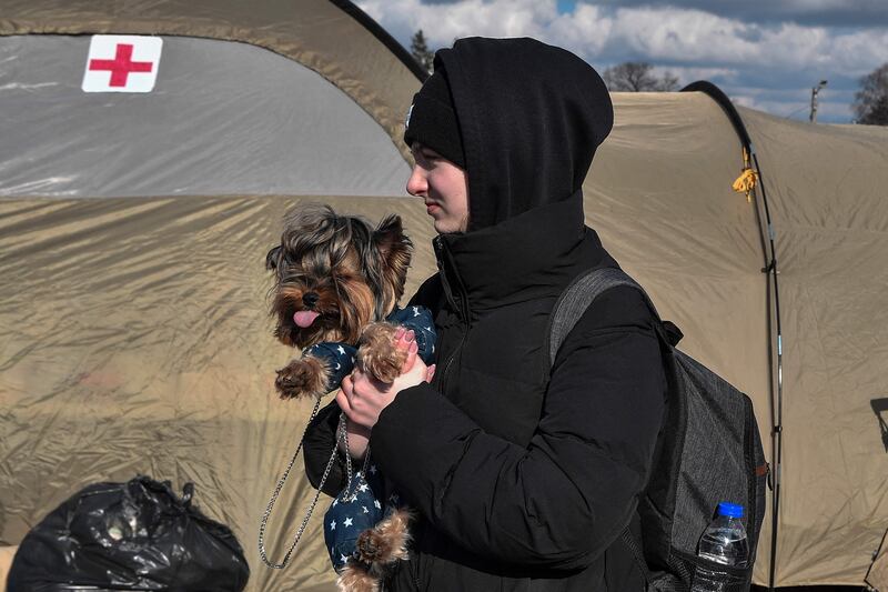 A young woman after crossing the Ukrainian border into Poland. Western officials say many refugees are suffering mental trauma and frostbite. AFP