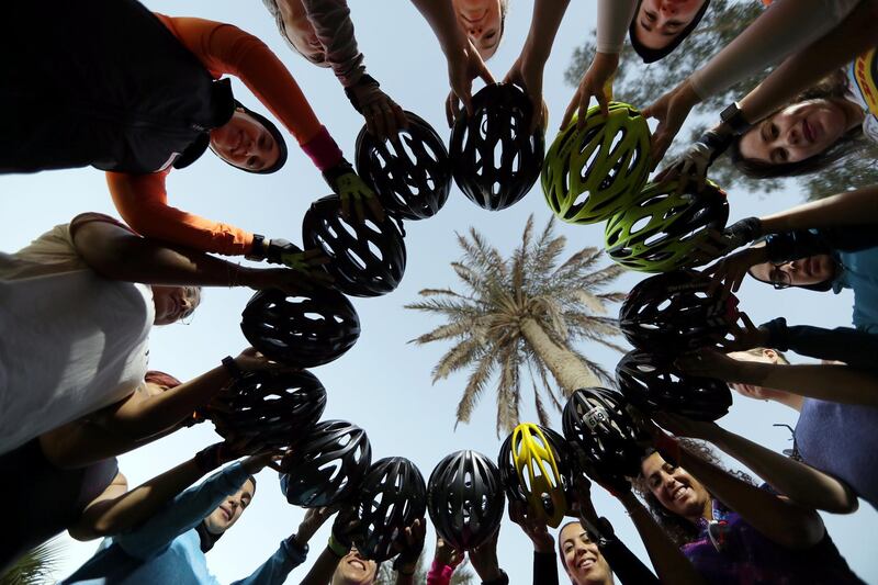 Members of a social cycling club, 'Cycling Bees', show off their cycling helmets before their ride in Manama, Bahrain. Reuters