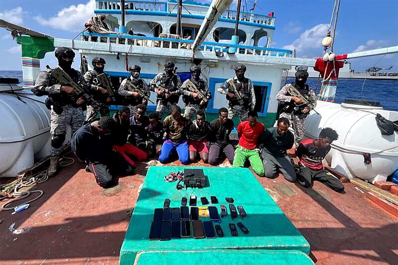 Indian Navy commandos with captured hijackers believed to be Somalian pirates on Tuesday. Photo: Indian Navy