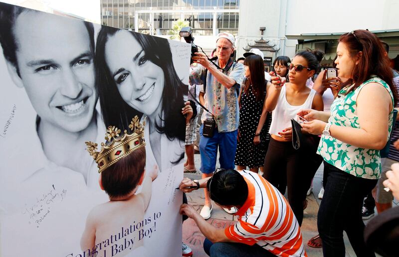Fans and tourists sign a giant card congratulating Britain's Prince William and Kate, Duchess of Cambridge, on the birth of their baby boy Tuesday, July 23, 2013 outside the TCL Chinese Theatre in the Hollywood district of Los Angeles in Los Angeles Tuesday, July 23, 2013. (AP Photo/Nick Ut) *** Local Caption ***  Britan Royal Baby .JPEG-06d40.jpg