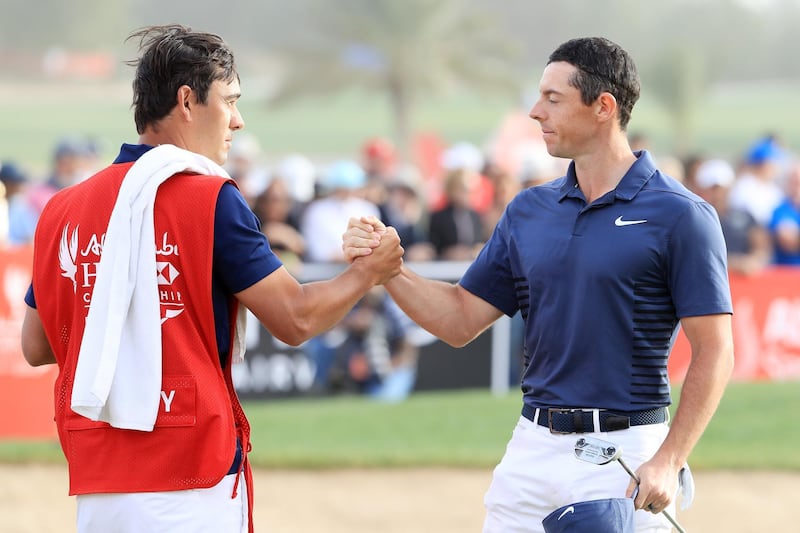 ABU DHABI, UNITED ARAB EMIRATES - JANUARY 21:  Rory McIlroy of Northern Ireland and caddie Harry Diamond shake hands after finishing on the 18th green during the final round of the Abu Dhabi HSBC Golf Championship at Abu Dhabi Golf Club on January 21, 2018 in Abu Dhabi, United Arab Emirates.  (Photo by Andrew Redington/Getty Images)