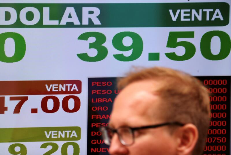 A man walks in front of a currency exchange board in Buenos Aires’ financial district, Argentina, September 3, 2018. REUTERS/Marcos Brindicci