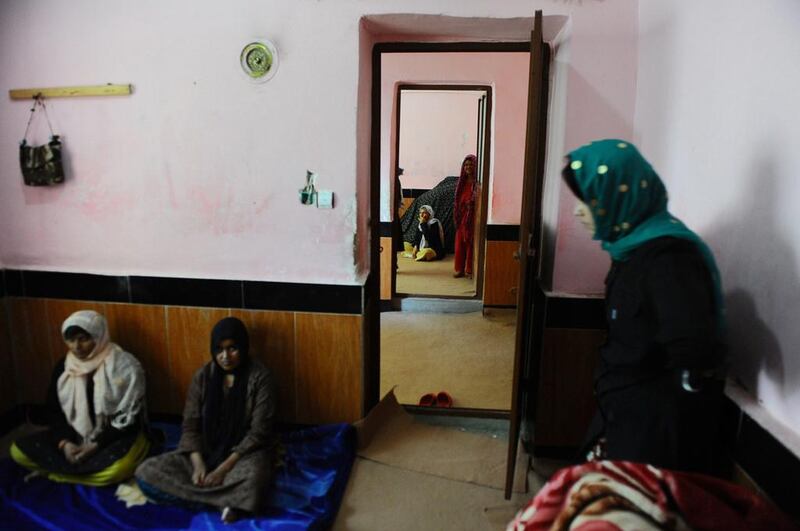 Patients sit inside their room in the female section of the centre.