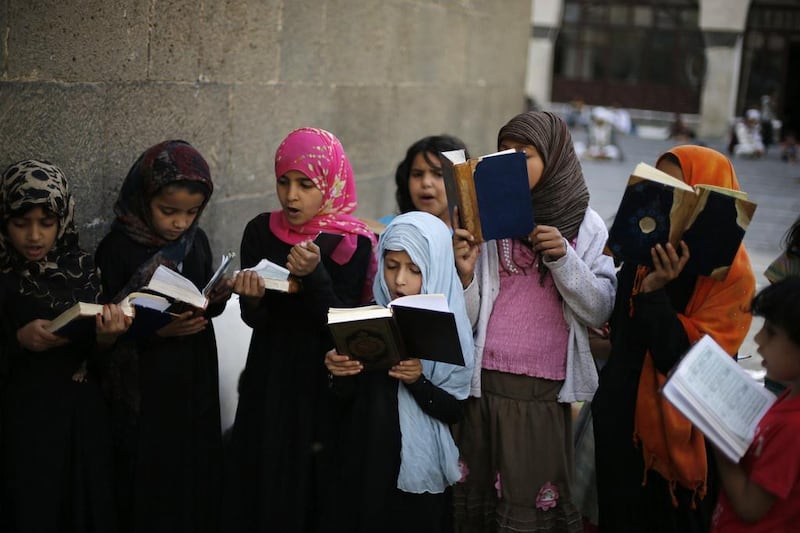 Girls recite the Quran at the Grand Mosque in Sanaa on the first day of the fasting month. Khaled Abdullah/Reuters