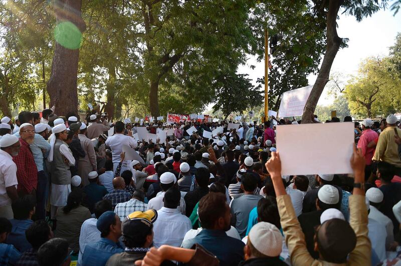 Muslim demonstrators hold placards as they participate in a peaceful protest against the Citizenship Amendment Bill (CAB) and the National Register of Citizens (NRC) in Ahmedabad on December 15, 2019. Some 5,000 people took part in a fresh demonstration in Guwahati on December 15, with hundreds of police watching on as they sang, chanted and carried banners with the words "long live Assam". / AFP / SAM PANTHAKY

