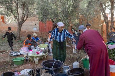Displaced people work in a kitchen area at a makeshift encampment by the side of the road between Marrakesh and Taroudant in the Atlas mountain range in the aftermath of the September 16 earthquake.  Photo: AFP