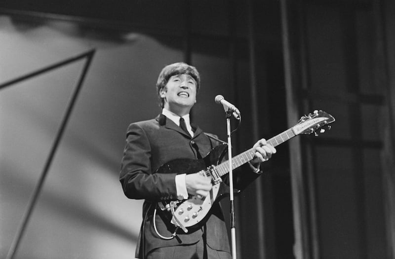 British singer-songwriter and musician John Lennon (1940 -1980) of The Beatles performing on stage at the London Palladium, UK, 13th October 1963. (Photo by Edward Wing/Daily Express/Hulton Archive/Getty Images)