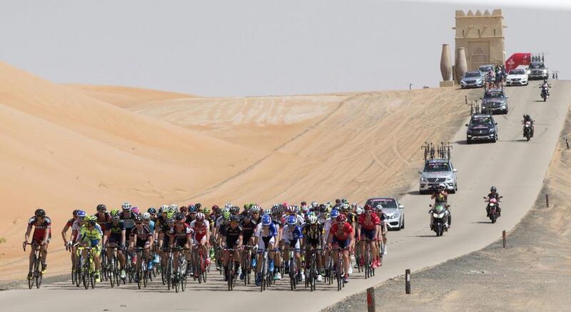 The peloton ride through the UAE desert on Thursday from Qasr Al Sarab to Madinat Zayed during Stage 1 of the Abu Dhabi Tour. Claudio Peri / ANSA / AP