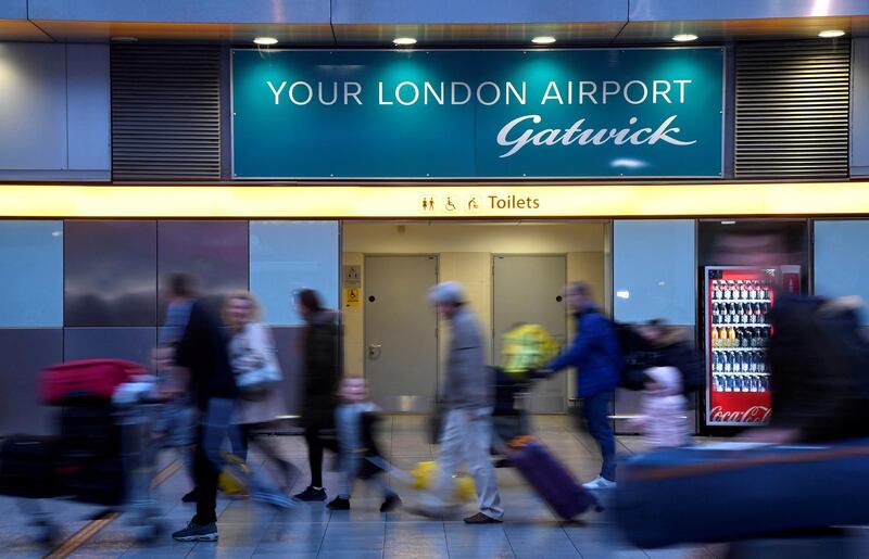 FILE PHOTO: Passengers walk through the South Terminal building at Gatwick Airport, after the airport reopened to flights following its forced closure because of drone activity, in Gatwick, Britain, December 21, 2018. REUTERS/Toby Melville/File Photo