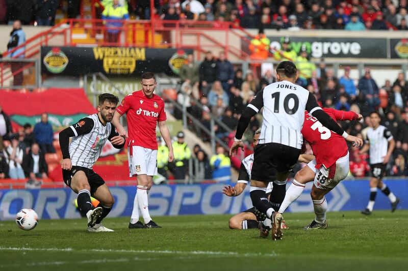 Wrexham's Elliot Lee scores their side's third goal. PA