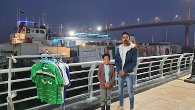 Mustafa Mohammed, 30, and his son Ibrahim, 6, on Basra Corniche as they enjoy the festive mood before the start of the tournament. Sinan Mahmoud / The National