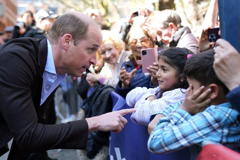 Prince William speaks to children in the crowd during a visit to Birmingham. Getty