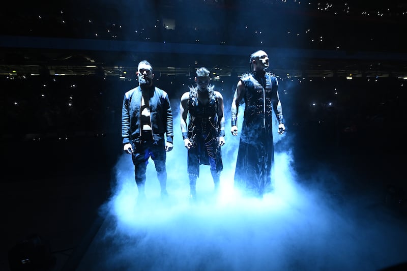 The Judgement Day with, from left, Finn Balor, Rhea Ripley and Damian Priest, make their entrance in the ring. 