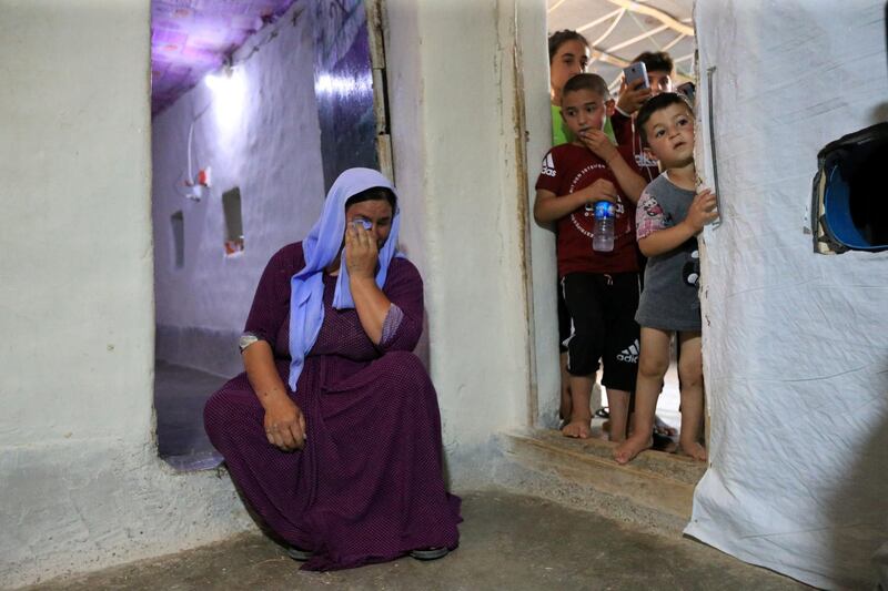 Displaced Yazidi Nayef al-Hamo's wife reacts before leaving home in Sharya town and heading back to Sinjar following the outbreak of the coronavirus disease near Dohuk, Iraq. Reuters