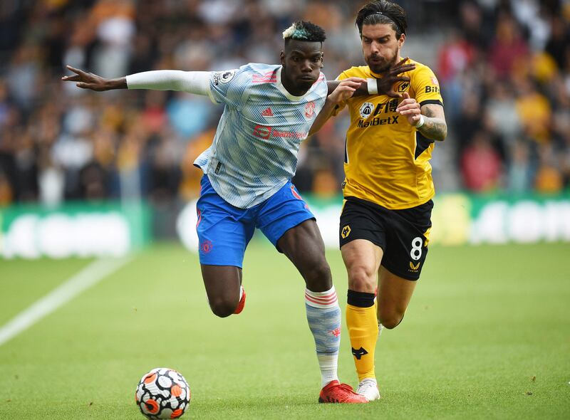 United's Paul Pogba under pressure from Ruben Neves of Wolves. AFP