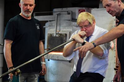 Outgoing British prime minister Boris Johnson blowing glass at the University of Sunderland. PA Wire