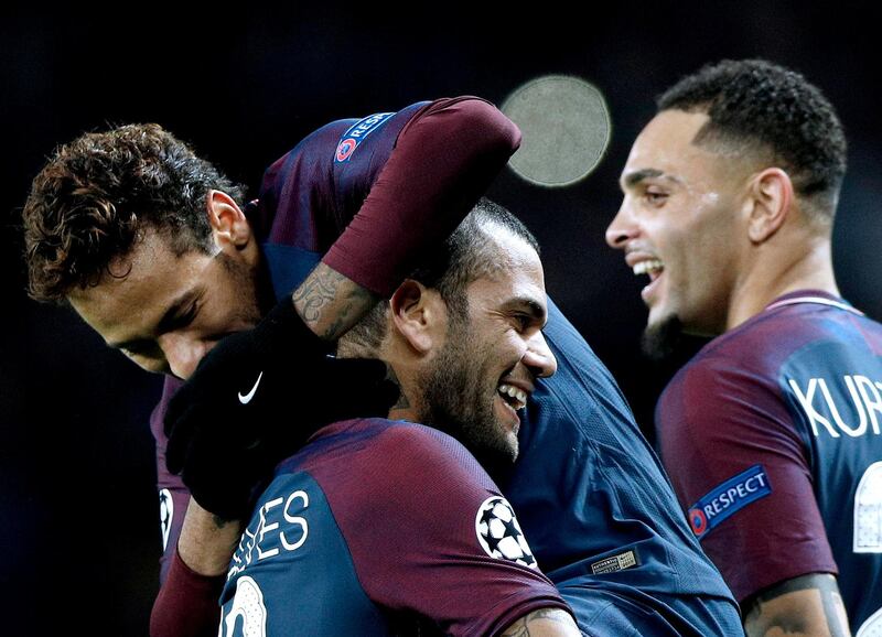 epa06344698 Dani Alves (C) of Paris Saint Germain celebrates with teammates Neymar (L) and Layvin Kurzawa (R) after scoring the 7-1 lead flanked by teammate Marquinhos (L) during the UEFA Champions League group B soccer match between Paris Saint-Germain and Celtic FC at the Parc des Princes Stadium in Paris, France, 22 November 2017.  EPA/YOAN VALAT