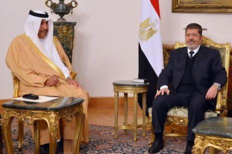 Mohammed Morsi, the Egyptian president, right, meets the Qatari prime minister, Hamad bin Jassim Al Thani in Cairo last month. Khaled Desouki / AFP