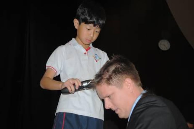provided photo of  Taewoong Jeong 
Teacher with shaved head is William Clark, Grade 5 teacher at Gems World Academy
Taewoong  was challenged to sing in public for a chance to cut his prof. hair 
Courtesy Gems World Academy