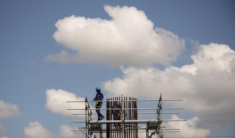 A worker stands on scaffolding at a construction site in Manila. Noel Celis / AFP