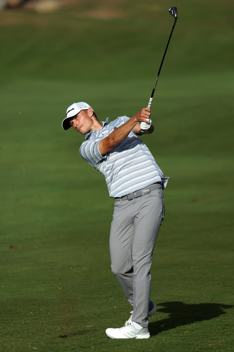 Nicolai Hojgaard plays his second shot at the 17th on his way to victory on day four of the Ras Al Khaimah Championship. Getty