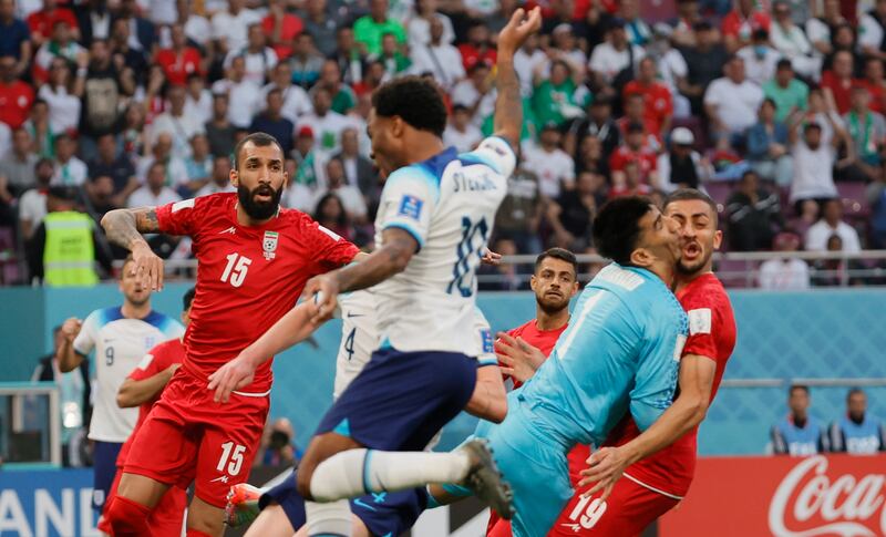 Iran's goalkeeper Alireza Beiranvand collides with teammate Majid Hosseini, right. He suffered a nasty injury and was substituted shortly after. EPA