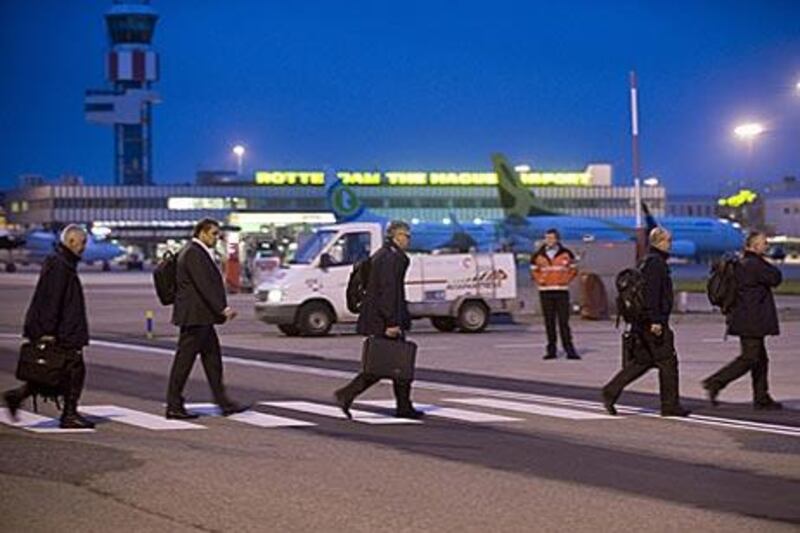 Members of the Disaster Identification Team (RIT) enter at a special plane bound for Libya at Rotterdam Airport this morning. Family members of the sole survivor of the crash were always on board.
