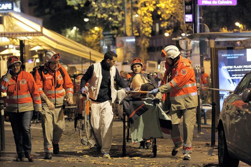 PARIS, FRANCE - NOVEMBER 14:  Medics evacuate an injured person on Boulevard des Filles du Calvaire, close to the Bataclan theater, early on November 14, 2015 in Paris, France. According to reports, over 150 people were killed in a series of bombings and shootings across Paris, including at a soccer game at the Stade de France and a concert at the Bataclan theater.  (Photo by Thierry Chesnot/Getty Images)