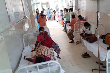 Patients and their bystanders are seen at the district government hospital in Eluru, Andhra Pradesh state. AP