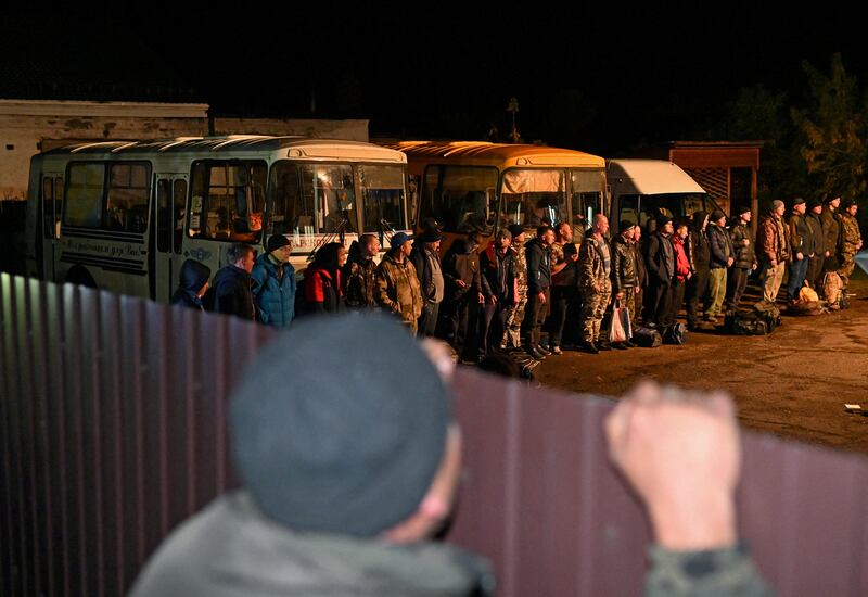 Russian reservists drafted during the partial mobilisation line up outside a recruitment office in the Siberian town of Tara in the Omsk region. Reuters