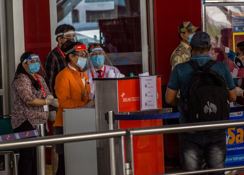 DELHI, INDIA - MAY 26: Indian travelers waits in queue at the drop-off point to enter Terminal 3 of the Indira Gandhi International Airport, as the country relaxed its lockdown restriction on May 26, 2020 in Delhi, India. With a slew of guidelines for passengers, India allowed commercial domestic flights to resume operations on May 25 for the first time since imposing a nationwide lockdown on March 25 to curb the spread of coronavirus which has reportedly claimed around 4,000 lives in India so far.  (Photo by Yawar Nazir/Getty Images)