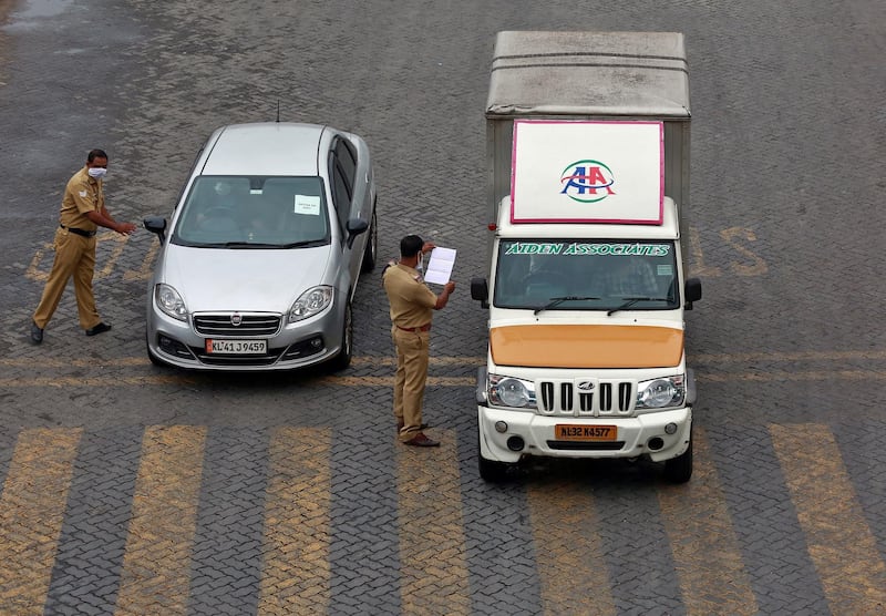 Police officers stop vehicles and check their papers on a highway during 21-day nationwide lockdown in Kochi, India. Reuters
