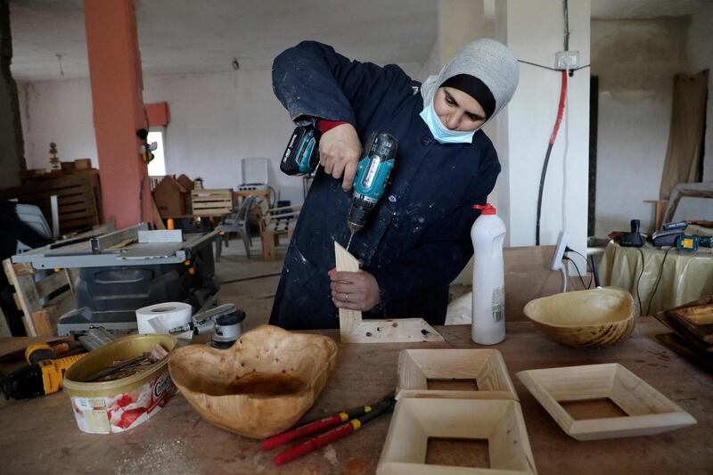 A Palestinian woman works at a carpenter workshop, established and run by a group of women, in the village of al-Walajeh near the West bank town of Bethlehem. AFP
