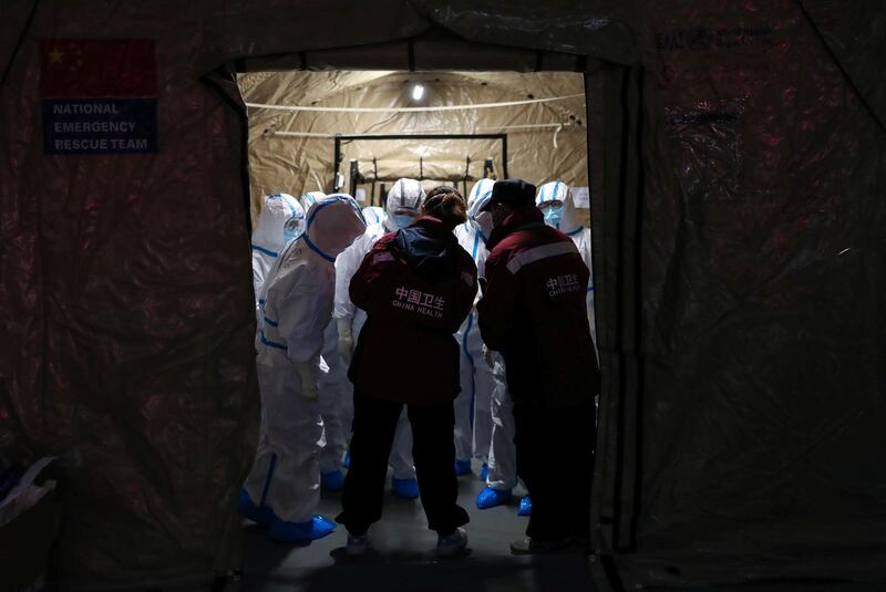 Medical workers in protective suits are seen at the Wuhan Parlor Convention Center, which has been converted into a makeshift hospital following an outbreak of the novel coronavirus, in Wuhan, Hubei province, China. Reuters