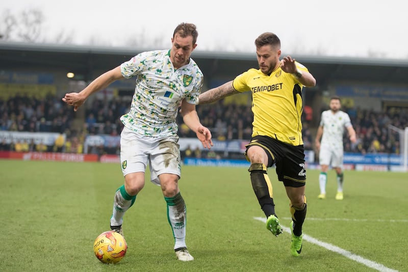 BURTON-UPON-TRENT, ENGLAND-FEBRUARY 18, 2017: Steven Whittaker of Norwich City and Michael Kightly  of Burton Albion in action during the Sky Bet Championship match between Burton Albion and Norwich City at Pirelli Stadium on February 18, 2017 in Burton-upon-Trent, England (Photo by Nathan Stirk/Getty Images).