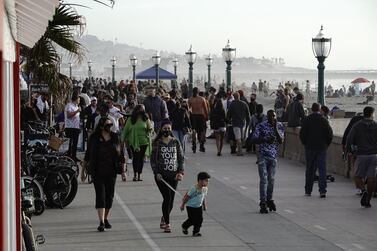 People walk along the Mission Beach boardwalk in San Diego, California, US. Bloomberg