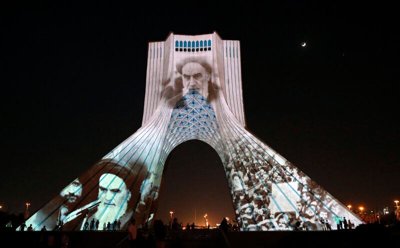 Iran's Azadi tower is illuminated with pictures of the late supreme leader Ayatollah Ruhollah Khomeini, to mark the 33rd anniversary of his death, in Tehran on June 3. AFP