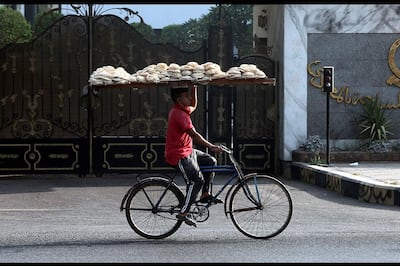 A  bakery worker delivers bread in Cairo, Egypt's capital. EPA