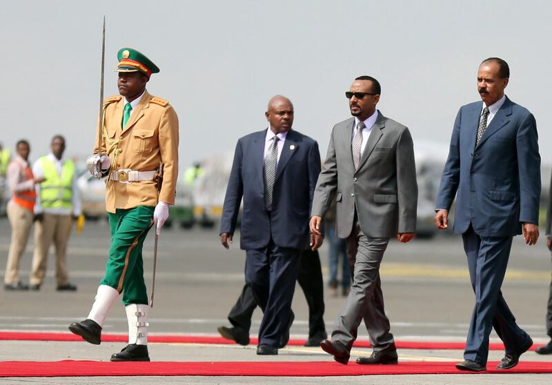 Eritrea's President Isaias Afwerki is welcomed by Ethiopian Prime Minister Abiy Ahmed upon arriving for a three-day visit, at the Bole international airport in Addis Ababa, Ethiopia July 14, 2018. REUTERS/Tiksa Negeri
