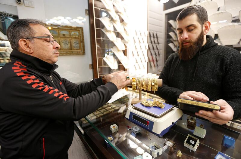 A customer looks at gold bracelets inside a jewellery shop in Beirut, Lebanon. REUTERS