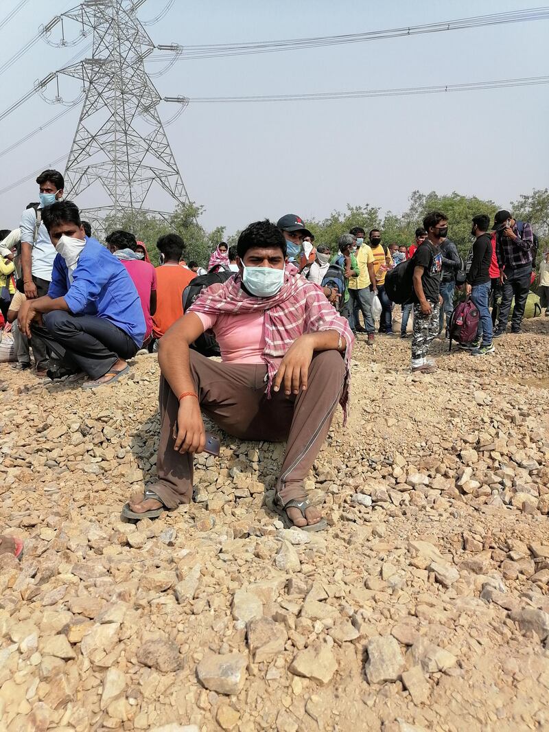 Migrant workers rest on National Highway 24, near Ghaziabad city on the outskirts of New Delhi, Taniya Dutta/The National